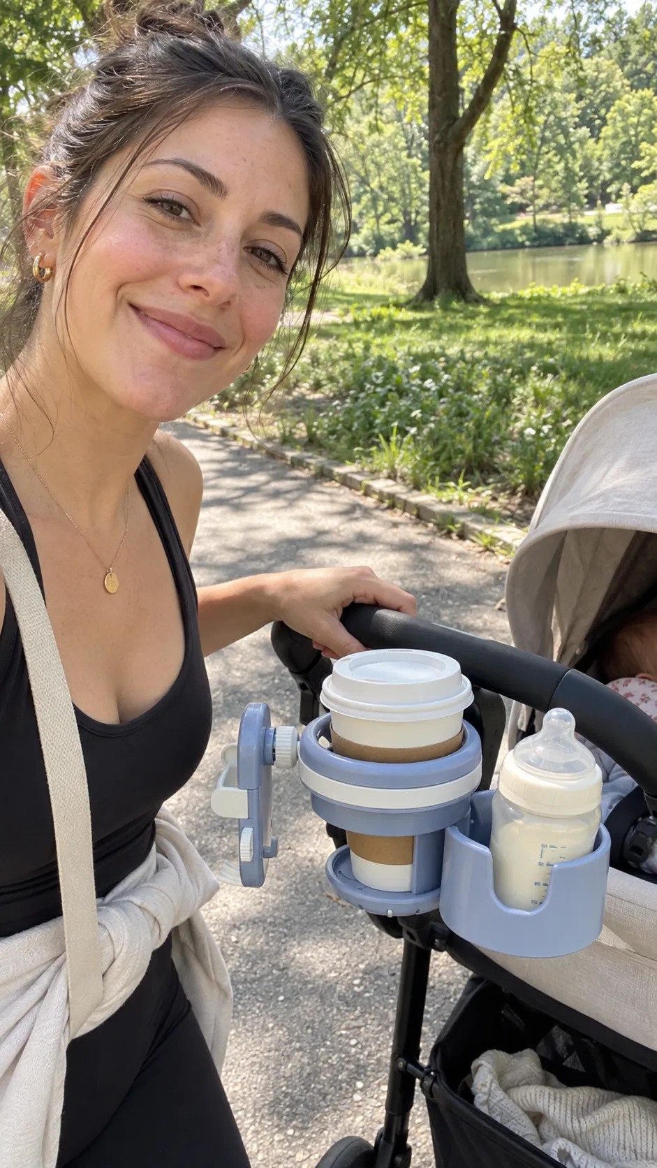 Mom with the stroller cup holder in the park